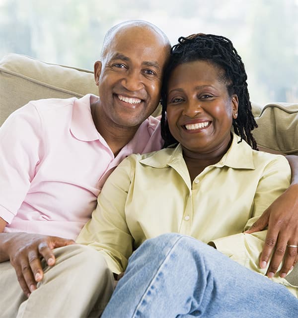 A happy couple reviewing their finances at home